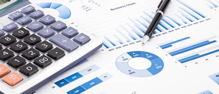 Calculator and pen with blue business charts, graphs, infomation and reports background for financial and business concepts